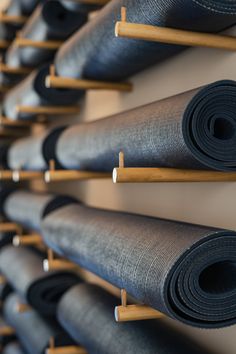 there are many rolled up yoga mats on the wall