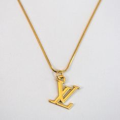 LV Logo Necklace Reluxe Vintage Lv Gold Necklace, Vintage Yellow Gold Jewelry With Logo Charm, Vintage Gold-tone Jewelry With Logo Charm, Vintage Gold-tone Necklace With Logo Charm, Luxury Gold Jewelry With Logo Charm, Vintage Pendant Necklace With Logo Charm, Luxury Gold Plated Pendant Charm Necklaces, Vintage Gold-plated Tarnish-resistant Charm Necklaces, Vintage Gold Plated Tarnish Resistant Charm Necklace