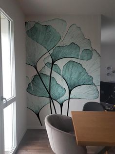 a dining room with a large painting on the wall next to a table and chairs