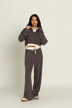 Our Charcoal Pullover Top will be the piece you are reaching for everyday to stay cozy and comfortable. Designed with fleece lining on the inside to keep you warm and the ideal slouchy fit for a day of relaxing or on the go. Complete with cream lined detailing to elevate any look. Pair with our Charcoal Wide Leg Pants for the perfect set. Relaxed Sweats For Winter Lounging, Relaxed Sweats For Lounging In Winter, Gray Sweats For Fall Loungewear, Casual Cotton Hoodie With Soft Knit, Cozy Gray Sweatshirt For Loungewear, Comfortable Gray Sweater For Loungewear, Comfy Soft Knit Sweatshirt For Loungewear, Gray Sweater With Ribbed Collar For Loungewear, Comfortable Gray Sweatshirt For Loungewear