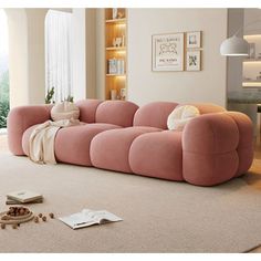 a pink couch sitting on top of a white rug