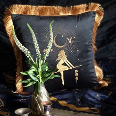 a decorative pillow and vase with plants in it