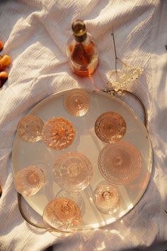 an assortment of wine glasses sitting on top of a white cloth next to a bottle