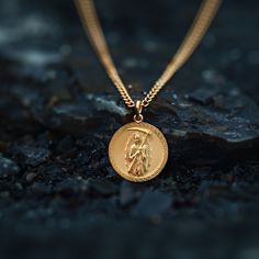 Our Gold Santa Muerte Pendant, crafted in the USA from real solid gold, embodies devotion and protection. This timeless piece showcases exquisite craftsmanship, designed to last a lifetime. Perfect for those seeking a unique and meaningful symbol, this pendant is a testament to enduring quality and elegance. PENDANT INFORMATIONThis pendant is made of real, solid gold.• Made in USA• Material: 14k or 18k solid gold• Finish: polished• Height: 1.13" (29 mm) x Width: 1" (26 mm)• Pendant weight: appro Spiritual Yellow Gold-plated Necklaces, Yellow Gold Plated Spiritual Necklace, Spiritual Yellow Gold Plated Necklaces, Spiritual Yellow Gold Brass Jewelry, Spiritual Recycled Gold Round Pendant Jewelry, Spiritual Recycled Gold Pendant Jewelry, Tarnish Resistant 14k Gold Chain Necklace With Round Pendant, 14k Gold Tarnish Resistant Chain Necklace With Round Pendant, Spiritual Recycled Gold Tarnish-resistant Jewelry