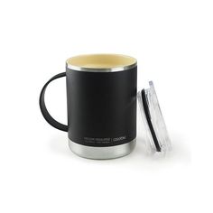 a black and yellow coffee mug sitting next to a glass container on a white surface