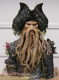 a statue of an octopus with long hair and beard on top of a cardboard box