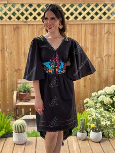 This Beautiful Dress boasts a Traditional Mexican floral design combined with a modern style dress. The embroidered bodice combined with the bell sleeves makes it fun and flirty. It's made out of fine Mexican cotton and has elastic on the back for an adjustable fit. This dress is handmade and hand embroidered by Mexican Artisans in Oaxaca, Mexico. This dress comes in one size: Medium/Large Purchase the shoes modeled here: https://www.etsy.com/es/listing/1001211818/tacones-mexicanos-pintados-a-ma Multicolor Embroidered Folk Dress With V-neck, Black Bohemian Dress With Embroidered Sleeves, Fitted Dresses With Geometric Embroidery For Festival, Folk V-neck Dress With Embroidered Hem, Folk Style V-neck Dress With Embroidered Hem, Fitted Geometric Embroidery Festival Dresses, Folk Style Embroidered Dress With Geometric Patterns And V-neck, Black Bohemian Embroidered Dress With Geometric Pattern, Fitted V-neck Embroidered Dress For Festival