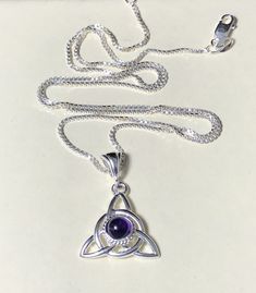 Did you enjoy Charmed, the TV show? I'll fabricate this sterling silver Celtic Trinity Knot pendant, approximately 1 inch in diameter, and I will set your choice of a 6mm round faceted or cabochon gemstone from the drop down menu. This comes with a 16 inch sterling silver box chain at 1.2mm thickness with a lobster claw for secure attachment. This is shown with a classic green Lab emerald faceted gemstone for the lucky lass in you! It's lovely, graceful and elegant...a timeless and classic tradi Sterling Silver Birthstone Necklaces For Healing, Healing Sterling Silver Birthstone Necklace, Spiritual Sterling Silver Birthstone Necklace With Gemstone, Silver Pendant Birthstone Necklace With Natural Stones, Sterling Silver Birthstone Necklace With Natural Stones, Silver Amethyst Birthstone Necklace As Gift, Silver Birthstone Pendant Necklace With Natural Stones, Silver Amethyst Birthstone Necklace For Gifts, Sterling Silver Round Birthstone Necklace With Natural Stones