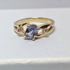 Beautiful Custom 14kt Yellow Gold Natural Blue Spinel Solitaire Ring With Diamond Accents. One .8 Ct Oval Grade A Natural Blue Spinel, With Two .035 Ct Round Diamonds. Size 6.75. Appraised Value $1,495.00 Blue Spinel Is One Of The Few Gemstones That Occur Naturally In Blue (I.E., Without Any Manmade Enhancements). Blue And Purple Hued Spinels Are Mined In Ceylon (Sri Lanka). Yellow Gold Tanzanite Diamond Ring With Accent Stones, Yellow Gold Diamond Ring With Tanzanite In Prong Setting, Heirloom Tanzanite Rings In Yellow Gold, Elegant Tanzanite Birthstone Ring With Prong Setting, Heirloom Tanzanite Yellow Gold Rings, Yellow Gold Tanzanite Rings With Accent Stones, Elegant Tanzanite Birthstone Ring With Center Stone, Fine Jewelry Yellow Gold Tanzanite Rings, Tanzanite Birthstone Ring In Fine Jewelry Style