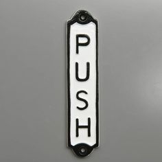 a push sign on the side of a gray vehicle with black lettering and white background