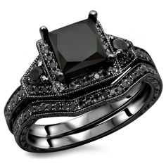 a black diamond engagement ring set on top of each other with matching wedding bands and band