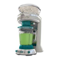 a green blender sitting on top of a white counter