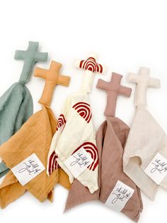 five different colored crosses with names on them