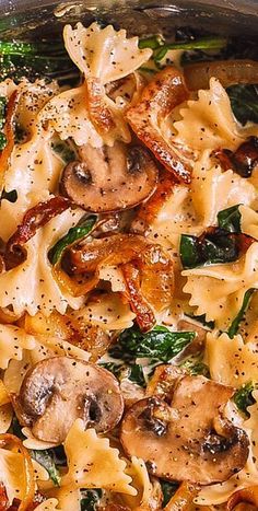 pasta with mushrooms and spinach in a pan