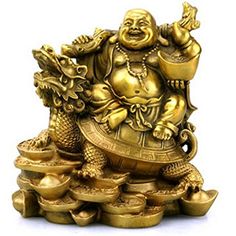 a gold statue sitting on top of a pile of coins