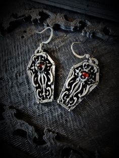 These gothic coffin earrings are handmade pewter sculptures with an antique finish These Coffin Earrings are sold with a surgical steel hooks The little coffin is 3cm top to bottom A set of necklace and earrings is also availlable in my shop These Gothic Coffins are a pewter sculpture of my own creation, i create and work the metal by myself at home. The material used is the finest and highest grade hypoallergenic pewter alloy of 98%tin You can combine many of my creations in an order to save on Nickel-free Surgical Steel Plug Earrings For Gift, Gothic Silver Surgical Steel Earrings, Gothic Sterling Silver Plug Earrings As Gift, Handmade Gothic Plug Earrings As Gift, Handmade Gothic Cross Jewelry, Medieval Jewelry For Halloween Gift, Collectible Gothic Brass Jewelry, Medieval Silver Jewelry For Halloween, Internally Threaded Metal Plug Earrings As Gift