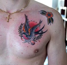 a man with a tattoo on his chest is wearing a cross and an orange flower