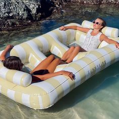 two women floating on inflatable rafts in the water next to each other