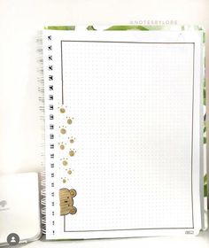 a notepad with a teddy bear drawn on it