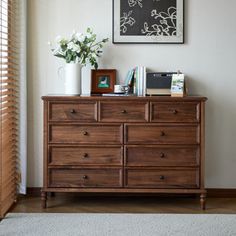 a wooden dresser sitting in front of a window