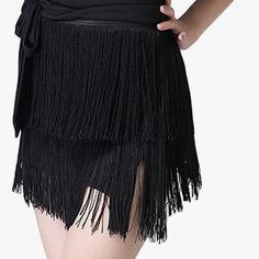 the woman is wearing a black skirt with fringes