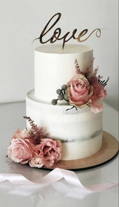 a white cake with pink flowers on top