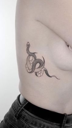 a woman with a snake tattoo on her stomach