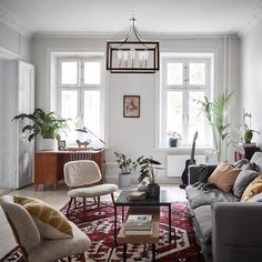 a living room filled with furniture and lots of windows