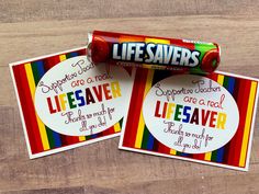 two candy bar wrappers sitting on top of each other next to a sticker that says life saver