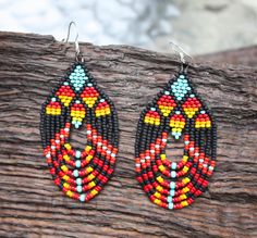 These stunning Native American beaded earrings are handcrafted with intricate geometric designs, featuring vibrant red and turquoise beads. Each pair is made with care and respect for traditional beadwork techniques, creating bold statement pieces perfect for any occasion. Add a touch of authentic cultural artistry to your style with these lightweight and eye-catching earrings. Colors may appear slightly different in person due to variations in computer monitors. Native American Beaded Earrings, Boho Geometric, Earrings Turquoise, Native American Beading, Geometric Jewelry, Bead Jewelry, Seed Bead Jewelry, Computer Monitors, Geometric Designs