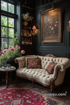 a couch sitting in front of a window next to a table with flowers on it