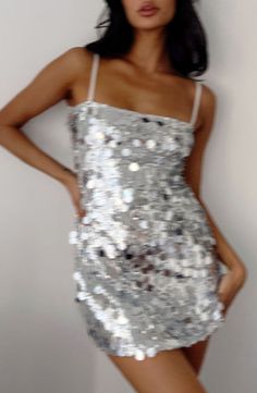 Silver Sequin Mini Dress

This item runs large, please size down

How to style:
Bring the disco to the party with this silver sequin () mini dress ()! This bold piece is perfect for concerts or a party! Pair it with dainty silver jewellery and cowboy boots () to complete the look.

Features:
  
 * Strapless style - removable and adjustable spaghetti straps 
 * Silver sequins outer 
 * Bodycon fit 
 * Lined 
 * Mini length 
 * Slight stretch 
 * Mid weight material 
 * Pull on style 
 * It is rec Silver Big Sequin Dress, New Year Eve Party Outfit, Gold And Silver Bachelorette Party, Sequin Outfits For Women, Silver Dress Accessories, All Silver Outfit, Concert Outfit Ideas Rap, Sequin Bachelorette Party Outfit, Silver Dress Aesthetic