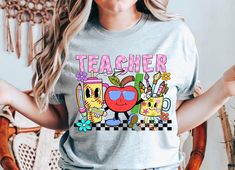 Celebrate the Spirit of Teaching with our Cute Teacher T-shirt from iPrintasy Embrace the warmth and joy of education with our Cute Teacher T-shirt from iPrintasy. Perfect as a gift for the dedicated educators in your life, this shirt is a delightful blend of colorful charm and heartfelt appreciation, making it an ideal present for teacher appreciation, back-to-school, or any special occasion. Vibrant Design: Our T-shirt features a vibrant heart design that symbolizes the love and dedication teachers bring to their classrooms every day. This eye-catching graphic is both cheerful and inspiring, making it a perfect way to celebrate the teaching profession. Premium Quality: Crafted from a soft and breathable cotton blend, this T-shirt ensures all-day comfort and durability. The high-quality f Educational Graphic Print Crew Neck T-shirt, Fun T-shirt With Funny Print For Teacher Appreciation, Fun Graphic Print T-shirt For Teacher Appreciation, Fun Teacher Appreciation T-shirt With Graphic Print, Back To School Graphic Tee For Teaching, Fun Back To School T-shirt, Fun Short Sleeve Tops For Teaching, Back To School Multicolor Fun T-shirt, Multicolor Fun T-shirt For Back To School