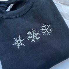 a black shirt with white snowflakes on it