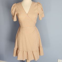 Brand New With Tag Short Sleeve Wrap Dress With Ruffle Trim And Puff Sleeves. Small Snap At Bust. True Wrap Style With Self Tie Belt. Light Brown Tan And Creamy White Gingham Plaid. Polyester Rayon Spandex Blend, Lightweight For Warm Weather. Loft Outlet. Size 2. Appx Measurements Laid Flat: Armpit To Armpit (When Bust Is Snapped) 16", Shoulder To Hem Length 34". Fitted V-neck Plaid Dress For Spring, Cute Fitted Mini-length Plaid Dress, Fitted Gingham Plaid Dress With V-neck, Gingham Mini Dress With Short Sleeves For Brunch, Gingham Short Sleeve Mini Dress For Brunch, Fitted Gingham Mini Dress With V-neck, Short Sleeve Gingham Mini Dress For Brunch, Knee-length Gingham Plaid Dress For Brunch, Casual Fitted Plaid Dress With Puff Sleeves