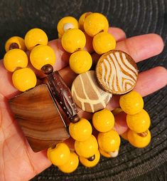 Made with large yellow wood beads and comes on clear stretch cord. Yellow Wooden Bead Bracelets, Yellow Wooden Beads Bracelet, Adjustable Yellow Bracelet With Wooden Beads, Yellow Bracelet With Round Wooden Beads, Adjustable Yellow Wooden Beaded Bracelets, Yellow Wooden Beads For Beach, Yellow Wooden Beads Bohemian Bracelet, Adjustable Yellow Bracelet With Large Beads, Bohemian Yellow Stretch Bracelet With Large Beads