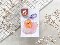 an animal shaped keychain sitting on top of a card