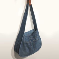 Large shoulder bag made of repurposed blue jeans.  Features original beltloops, functional pockets and leather brand patch. Lining and piping is also recycled denim. Measurements: 46cm x 72cm x 16cm Recycled Denim Bags, Denim Bags, Couture Sewing, Recycled Denim, Large Shoulder Bags, Denim Bag, Shoulder Tote Bag, Shoulder Tote, Piping