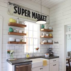 a kitchen with white brick walls and open shelving above the sink that says super market