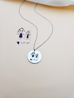 Kids Drawing Necklace, Children Handwriting Necklace for Mom, Custom Child Artwork Jewelry, Personalized Gift for Grandma, Keepsake Jewelry. Turn your children's drawing or writing into a necklace. This necklace is not just an accessory, it's a precious keepsake that celebrates the boundless creativity of your little one. Your child's cherished drawing forever preserved in a stainless steel charm. Each line, every curve, and all the details are meticulously engraved with laser precision, ensuring that the essence of your child's artwork is beautifully preserved. HOW TO ORDER Scan or take a picture of the design, use the ASK A QUESTION OR CONTACT SHOP OWNER button to send us your design. Material: Stainless Steel, Gold or Rose Gold Plated Stainless Steel. Finish: Stainless Steel, Gold, Rose Handmade Charm Necklace For Birthday And Mother's Day, Adjustable Stamped Necklace For Gifts, Adjustable Stamped Necklace As Gift, Handmade Round Charm Necklace For Birthday, Artistic Personalized Necklace, Artistic Personalized Round Necklace, Artistic Personalized Round Pendant Necklace, Stamped Necklaces For Valentine's Day Gift, Stamped Pendant Necklaces As Gift