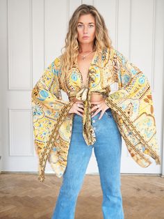 SILK BELL SLEEVE CROP TOP - SUMMER FIELDS  ** LIMITED PRINTS AVAILABLE **  Handmade recycled silk crop kimono with amazing billowing bell sleeves and gold printed fabric!  The gold thread print shimmers and shines, the photos don't do it justice. This incredible silk crop top is the perfect addition to any outfit, with flowing sleeves and bohemian vibe, this is an amazing bespoke piece to add to any wardrobe!  Our 'Bella' tops were dreamed up in the sunshine and are a twist on our classic 'Stevi Stretch V-neck Top For Festival, Stretch Long Sleeve Tops For Vacation, Printed Long Sleeve Tops For Beach, Flowy V-neck Printed Tops, Fitted Long Sleeve Tops For Beach, Fitted Long Sleeve Tops For The Beach, Fitted Long Sleeve Beach Top, Printed V-neck Top For Festival, Festival V-neck Printed Top