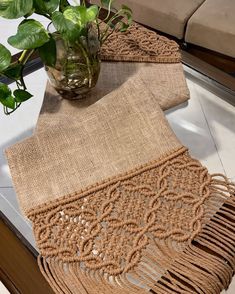 the table is set with two placemats and a potted plant