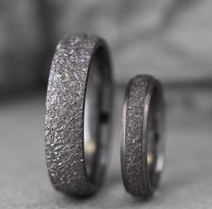 two wedding bands made out of silver glitter