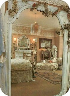 an ornate white mirror reflecting a bedroom scene