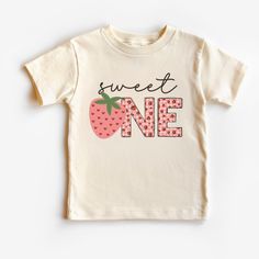 a white t - shirt with the words sweet one printed on it and a strawberry