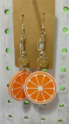 Handmade Macrame beaded earrings with 3D printed orange slice charms. Orange Drop Earrings For The Beach, Orange Drop Earrings For Beach, Orange Dangle Jewelry For Beach, Casual Orange Jewelry For Beach, Casual Orange Beach Jewelry, Orange Adjustable Beaded Drop Earrings, Adjustable Orange Beaded Drop Earrings, Nickel-free Orange Jewelry For Beach, Nickel-free Orange Jewelry For The Beach