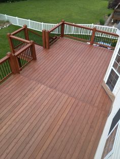 a wooden deck with railings and windows