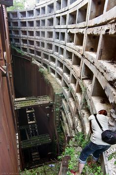 a person climbing up the side of a building with lots of concrete blocks on it