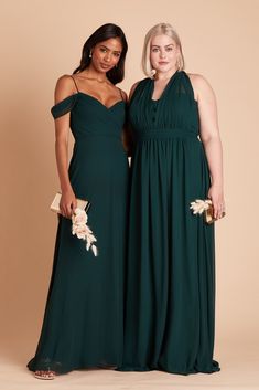 two women in long dresses posing for the camera with one woman wearing a green dress