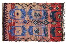 an old, colorful rug with fringes and designs on the edges is shown in red, blue, and beige colors